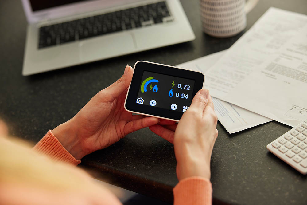 Holding Smart Energy Meter in kitchen