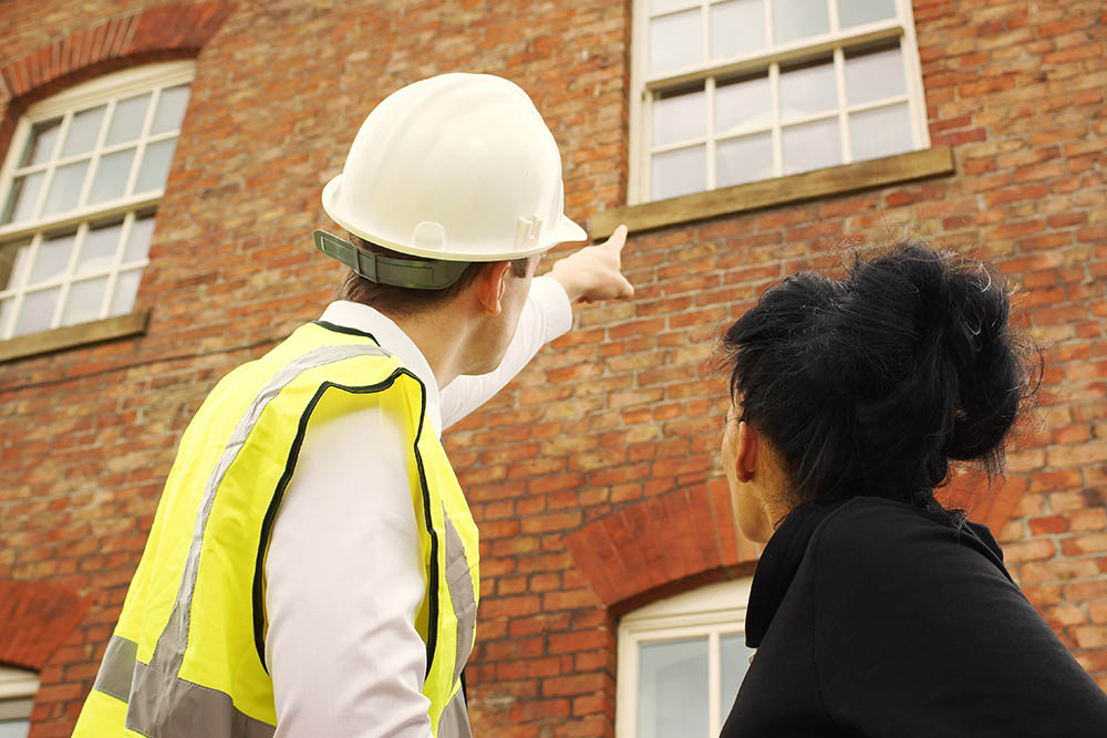 Contractor and homeowner looking at a property