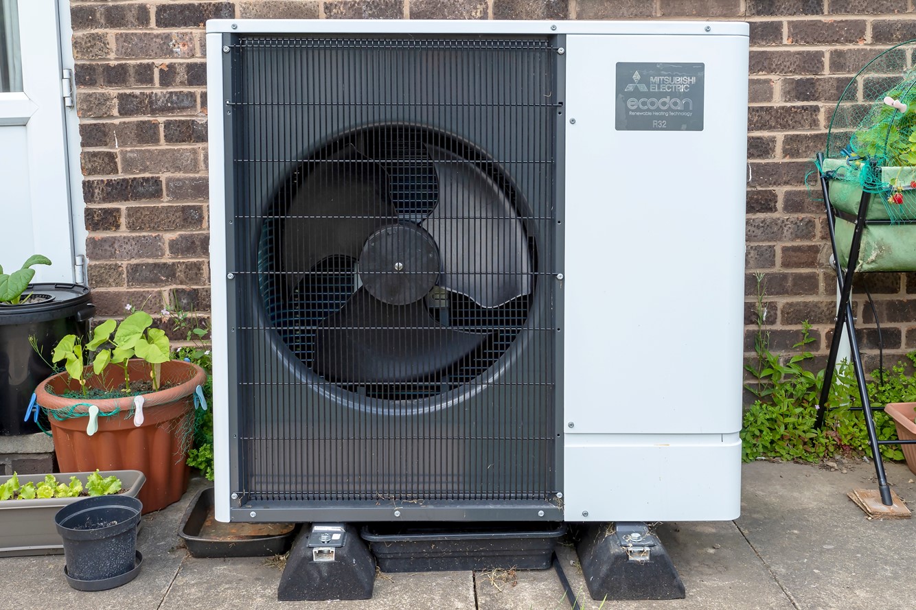 Image of a heat pump outside a home